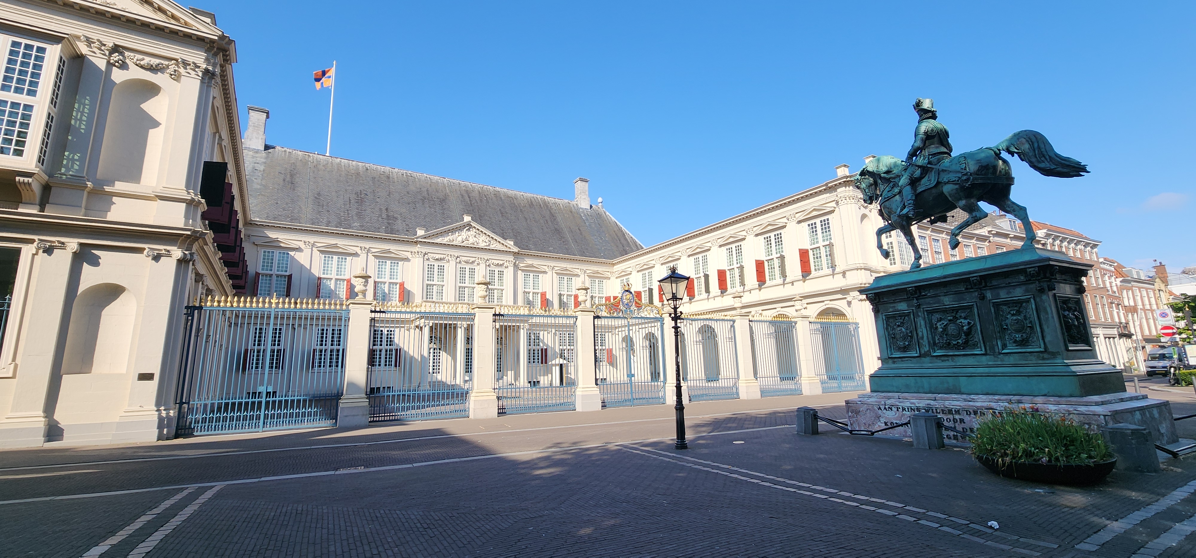 Front entrance and gate of the palace with statue in front