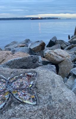 View over the sea with rocks in the foreground