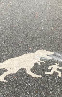 Photo of walking path with dinosaur printed on it